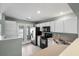 Bright kitchen boasts white cabinets, stainless steel appliances, and recessed lighting at 125 Greyson Cir, Goose Creek, SC 29445