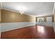 Bright living room featuring hardwood floors, wainscoting, modern lighting, and natural light at 125 Greyson Cir, Goose Creek, SC 29445