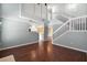 Open living room with hardwood floors, staircase, and view into the kitchen at 125 Greyson Cir, Goose Creek, SC 29445