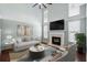 Staged living room boasts a fireplace, comfortable seating, and natural light at 125 Greyson Cir, Goose Creek, SC 29445