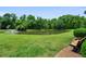 Scenic view of community pond with a water feature and lush landscaping at 125 Greyson Cir, Goose Creek, SC 29445