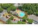 Aerial view of a community pool with chairs and landscaping, surrounded by lush greenery and parking area at 125 Greyson Cir, Goose Creek, SC 29445