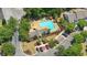 Aerial view highlighting a pool, community building, parking area, and lush landscaping at 125 Greyson Cir, Goose Creek, SC 29445