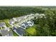An aerial view of a peaceful neighborhood surrounded by lush greenery, showcasing beautiful homes and manicured lawns at 125 Integrity Ln, Charleston, SC 29492