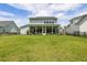 Expansive backyard offers ample space for outdoor activities and entertainment, with a view of the home at 125 Integrity Ln, Charleston, SC 29492