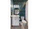 Charming bathroom featuring bold blue and green wallpaper, a white vanity, and gold fixtures at 125 Integrity Ln, Charleston, SC 29492