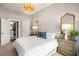 Bright bedroom with light gray walls, a modern gold chandelier, and an ensuite bathroom at 125 Integrity Ln, Charleston, SC 29492