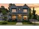Beautiful two-story home featuring an inviting front porch with manicured lawn under a dramatic evening sky at 125 Integrity Ln, Charleston, SC 29492