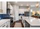 Modern kitchen featuring white cabinetry, stainless steel appliances, and a large island with quartz countertops at 125 Integrity Ln, Charleston, SC 29492