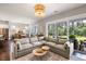 Inviting living room with a large sectional sofa, sliding glass doors, and backyard view at 125 Integrity Ln, Charleston, SC 29492