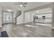 Bright, open-concept living room and kitchen with light wood floors and stainless steel appliances at 125 Integrity Ln, Charleston, SC 29492