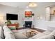 Cozy living room featuring a fireplace, large sectional sofa, and stylish decor at 125 Integrity Ln, Charleston, SC 29492