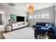 Spacious living room with a large, comfortable blue sectional sofa and modern decor at 125 Integrity Ln, Charleston, SC 29492