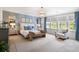 Relaxing primary bedroom featuring a large bed, bench, and large windows at 125 Integrity Ln, Charleston, SC 29492
