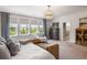 Light-filled primary bedroom featuring a large bed, windows, and light gray walls at 125 Integrity Ln, Charleston, SC 29492