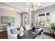 Serene home office with stylish lighting, a dark desk, and a view to the outside at 125 Integrity Ln, Charleston, SC 29492