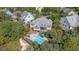 Stunning aerial view of coastal home with a private pool and deck surrounded by lush trees at 1308 Divot Ct, Mount Pleasant, SC 29466