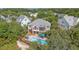 Aerial view of home with lush landscaping, mature trees, and relaxing pool area at 1308 Divot Ct, Mount Pleasant, SC 29466