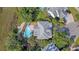 Aerial view of landscaped backyard, pool, deck, and patio seating at 1308 Divot Ct, Mount Pleasant, SC 29466