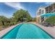View of the home's backyard showing the outdoor pool and upper level sunroom at 1308 Divot Ct, Mount Pleasant, SC 29466