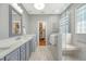 Bathroom with double vanity, walk-in shower with glass door, and marble flooring at 1308 Divot Ct, Mount Pleasant, SC 29466