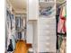 Organized walk-in closet with built-in shelving, drawers, and hardwood flooring at 1308 Divot Ct, Mount Pleasant, SC 29466