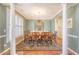Formal dining room with hardwood floors, a large dining table, chandelier, and views of the exterior at 1308 Divot Ct, Mount Pleasant, SC 29466