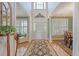 Elegant foyer boasting hardwood floors, a decorative rug, and views into the dining and living areas at 1308 Divot Ct, Mount Pleasant, SC 29466