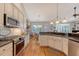 Well-equipped kitchen with stainless steel appliances, granite countertops, and hardwood floors at 1308 Divot Ct, Mount Pleasant, SC 29466