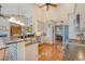Bright kitchen with stainless steel appliances, white cabinetry, and a brick-accented breakfast bar, adjacent to the dining area at 1308 Divot Ct, Mount Pleasant, SC 29466