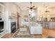 Spacious open-plan living room connected to the kitchen, featuring a fireplace, breakfast bar, and hardwood floors at 1308 Divot Ct, Mount Pleasant, SC 29466