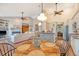Open-concept space featuring a kitchen with white cabinets, a brick breakfast bar, and a comfortable living room with a fireplace at 1308 Divot Ct, Mount Pleasant, SC 29466