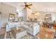 Bright, open-concept living space with comfortable seating, large windows, and seamless flow to the dining area at 1308 Divot Ct, Mount Pleasant, SC 29466