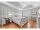 Main bedroom with tray ceiling, hardwood floors, a ceiling fan and plenty of natural light at 1308 Divot Ct, Mount Pleasant, SC 29466