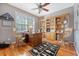 Charming home office with hardwood floors, built-in bookshelves, a classic desk, and plenty of natural light at 1308 Divot Ct, Mount Pleasant, SC 29466
