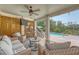Inviting covered patio with wicker furniture, ceiling fan, and a view of the sparkling pool at 1308 Divot Ct, Mount Pleasant, SC 29466