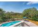 Inviting pool area overlooking a tranquil wetland with lush greenery and a comfortable seating area at 1308 Divot Ct, Mount Pleasant, SC 29466