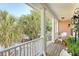 Relaxing porch featuring white railings, rocking chairs, and a scenic view of palm trees and neighborhood at 1308 Divot Ct, Mount Pleasant, SC 29466