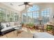 Inviting sunroom featuring large windows, comfortable seating, and peaceful views of the outdoors at 1308 Divot Ct, Mount Pleasant, SC 29466