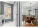 A dining room can be seen from the laundry room, featuring hardwood floors, a chandelier and wooden table at 1458 Clarendon Way, Mount Pleasant, SC 29466