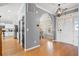 Open foyer showcasing hardwood floors, an arched doorway, and views into the kitchen and dining areas at 1458 Clarendon Way, Mount Pleasant, SC 29466