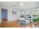 A sunny sunroom with vaulted ceilings, and hardwood floors creates a peaceful spot for relaxation and entertaining at 1458 Clarendon Way, Mount Pleasant, SC 29466