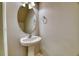 Bathroom featuring a pedestal sink, oval mirror, chrome fixtures, and neutral paint at 149 Woodward Rd, Goose Creek, SC 29445