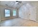 Bright bedroom with two large windows, vaulted ceiling, closet, and door, featuring hardwood floors and a ceiling fan at 149 Woodward Rd, Goose Creek, SC 29445