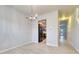 Open dining room with chandelier and view of kitchen and hallway with plenty of natural light at 149 Woodward Rd, Goose Creek, SC 29445