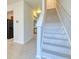 Bright entryway with a staircase featuring white risers and hallway leading to kitchen with stainless appliances at 149 Woodward Rd, Goose Creek, SC 29445