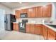 Kitchen with ample wood cabinetry, stainless appliances, light countertops and new refrigerator at 149 Woodward Rd, Goose Creek, SC 29445