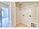 This light laundry room features connections for washer and dryer and a wire shelf at 149 Woodward Rd, Goose Creek, SC 29445