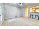 Bright living room features bar seating to the kitchen, light walls, hardwood floors, and a door to the outside at 149 Woodward Rd, Goose Creek, SC 29445