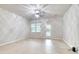 Bright, open living room with white walls, wood floors, ceiling fan, and a door to the outside at 149 Woodward Rd, Goose Creek, SC 29445